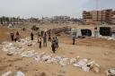 Bodies lined up for identification after they were unearthed from a mass grave found in the Nasser Medical Complex in the southern Gaza Strip