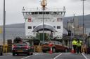 Vehicles board the CalMac ferry MV Bute  at Wemyss Bay for Rothesay