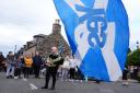 Alex Salmond's body returned home to Scotland on Friday with crowds lining the street to pay tribute