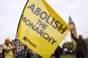 Protesters hold an 'abolish the monarchy' banner as anti-monarchy group Republic stage a protest in Parliament Square on Budget Day