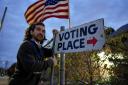 Election Day worker Sean Vander Waal prepares to open a polling place in Dearborn, Michigan