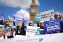 Campaigners in support of voluntary euthanasia protest outside Parliament in Westminster, London