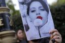 Demonstrators hold placards outside the Iranian Embassy in London