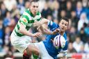 Ferguson and Brown contest a ball during an Old Firm derby