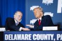 Mike Huckabee speaks with Donald Trump at a community roundtable