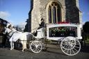 A horse-drawn carriage carrying the coffin of Liam Payne arrives for the funeral service of One Direction singer