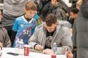 Star Kyle Benedictus signs a calendar at a previous Pars event.