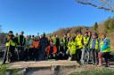 Volunteers are pictured at the Tom Weir statu