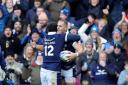 Scotland's Duhan van der Merwe celebrates scoring his 30th international try with captain Sione Tuipulotu