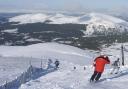 Skiers and snow boarders on the M2 run at the Cairngorm ski area, Aviemore