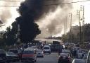 Black smoke rises from the scene where a fuel tanker exploded, in Tleil village, north Lebanon, Sunday, Aug. 15, 2021. A fuel tanker exploded early Sunday in northern Lebanon, killing and wounded several people, the Lebanese Red Cross said. The explosion