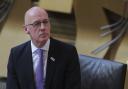 John Swinney has told MSPs the government is no longer seeking to suppress Covid to its lowest levels