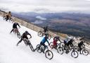 Mountain bikers race down snowy Scottish peak in 'Macavalanche' event