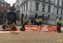 Scottish activists with the Just Stop Oil coalition glued themselves outside Downing Street on Wednesday