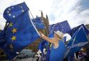 Anti-Brexit demonstrators wave European Union flags outside the Houses of Parliament