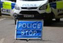 Stock image of a police sign and van