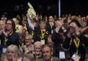 Delegates cheer an announcement during an SNP conference