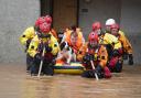 Members of the emergency services help local residents to safety in Brechin, Scotland