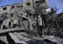 A Palestinian boy stands amid the destruction after an Israeli strike in Rafah, Gaza Strip
