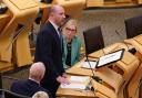 Wellbeing Economy Secretary Neil Gray speaking in the Holyrood chamber