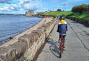 A child cycling to Blackness Castle