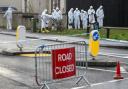 Forensic officers on the scene of a shooting on Hogmanay