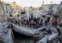 People inspect the damage to their homes following Israeli air strikes in Rafah, Gaza