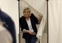 French far-right leader Marine Le Pen exits a voting booth
