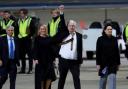 WikiLeaks founder Julian Assange gestures as he arrives at Canberra Airport on June 26, 2024