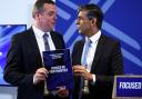 Scottish Conservative leader Douglas Ross and British Prime Minister Rishi Sunak pose with a copy of The Scottish Conservative and Unionist Party Manifesto