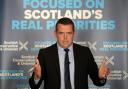 A Scottish Tory campaigner is facing criticism for posts he shared with a far-right party