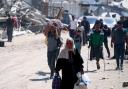 Palestinians displaced by Israeli strikes last night leave Khan Younis