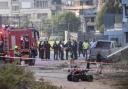 Israeli police officers and firefighters work at the site of a rocket attack in Majdal Shams, in the Israeli-controlled Golan Heights