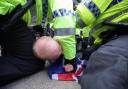 Police restrain a man during a far-right protest in Liverpool