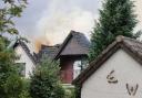 Smoke billowed from a large hole in the roof after the property was struck by lightning