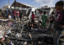 Palestinians inspect the damage at a tent area in the courtyard of Al Aqsa Martyrs hospital, hit by an Israeli bombardment on Deir al-Balah, Sunday, August 4, 2024