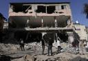 People look at destruction after an Israeli army raid on a Palestinian refugee camp, Nur Shams, in the West Bank last year