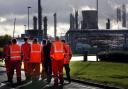 Workers walk through the Grangemouth oil refinery in Falkirk