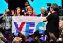 Former first minister Nicola Sturgeon  holds a Yes flag at SNP conference in 2019