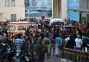 Ambulances are surrounded by people at the entrance of the American University of Beirut Medical Center