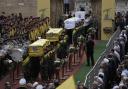 Hezbollah fighters carry the coffins of fallen four comrades who were killed Tuesday after their handheld pagers exploded