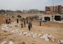 Bodies lined up for identification after they were unearthed from a mass grave found in the Nasser Medical Complex in the southern Gaza Strip