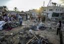 Palestinians inspect damage in the courtyard of Al Aqsa Martyrs hospital