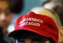 A person wears a Make America Great Again cap