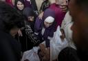 Palestinians mourn their relatives killed in the Israeli bombardment of the Gaza Strip at a hospital morgue in Deir al-Balah, Friday, Nov. 1, 2024. (AP Photo/Abdel Kareem Hana).