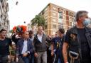 King Felipe VI of Spain (C) is heckled by angry residents who throw mud and objects during his visit to Paiporta