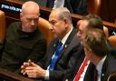 Israeli Prime Minister Benjamin Netanyahu (centre) has dismissed defence minister Yoav Gallant (left)