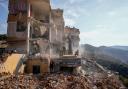 Rescue workers in the rubble of a destroyed building in Barja (Hassan Ammar/AP)