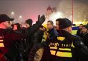 Police escort Maccabi Tel Aviv supporters to the metro station leading them to the Ajax stadium