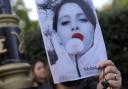 Demonstrators hold placards outside the Iranian Embassy in London